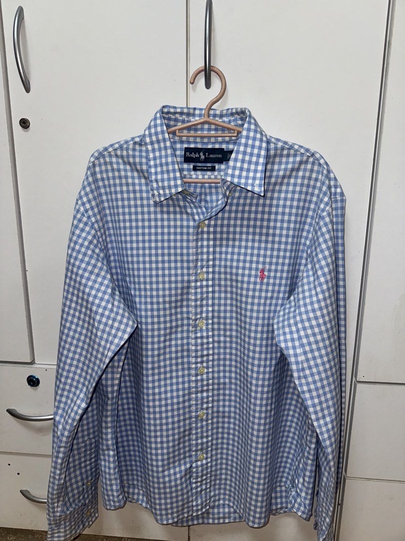 Ralph Lauren Gingham Long Sleeve Shirt (Category: Tshirts & Polo Shirts ) located in Manila. Submitted by quintessesommerset (Listing ID 1462650898, Image 1). Description: - Classic blue and white gingham pattern 23x28 - Brand: Ralph Lauren - Fit: Custom fit - Sleeves: Long with button cuffs - Detail: Iconic embroidered polo player logo on chest - Style: Versatile for casual or smart-casual occasions.