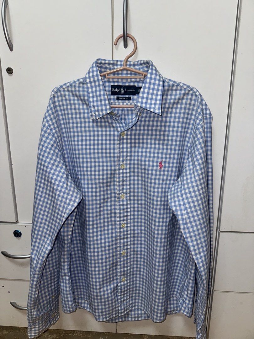 Ralph Lauren Gingham Long Sleeve Shirt (Category: Tshirts & Polo Shirts ) located in Manila. Submitted by quintessesommerset (Listing ID 1462650898, Image 2). Description: - Classic blue and white gingham pattern 23x28 - Brand: Ralph Lauren - Fit: Custom fit - Sleeves: Long with button cuffs - Detail: Iconic embroidered polo player logo on chest - Style: Versatile for casual or smart-casual occasions.