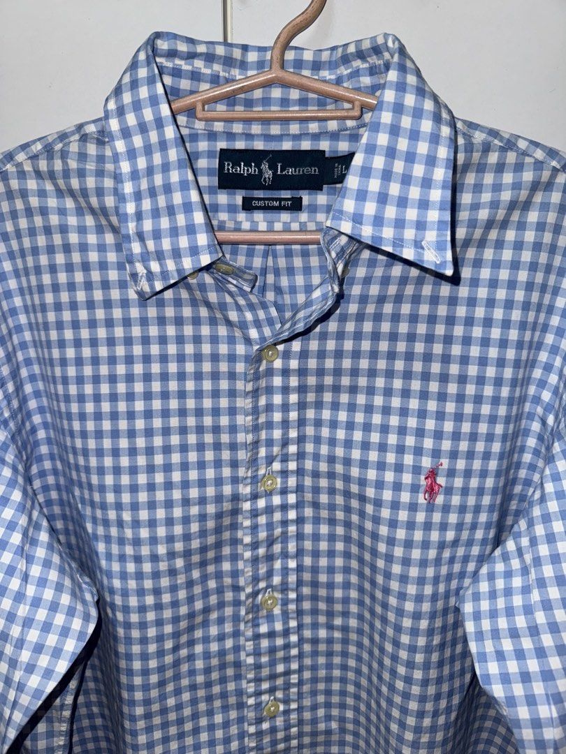Ralph Lauren Gingham Long Sleeve Shirt (Category: Tshirts & Polo Shirts ) located in Manila. Submitted by quintessesommerset (Listing ID 1462650898, Image 3). Description: - Classic blue and white gingham pattern 23x28 - Brand: Ralph Lauren - Fit: Custom fit - Sleeves: Long with button cuffs - Detail: Iconic embroidered polo player logo on chest - Style: Versatile for casual or smart-casual occasions.