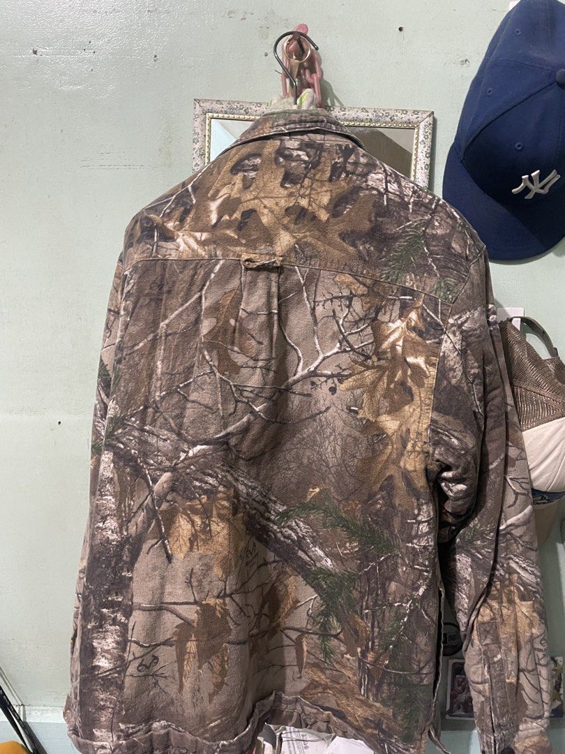 Real Tree Camo Button Up Jacket (Category: Coats, Jackets and Outerwear) located in Baguio. Submitted by claw_set (Listing ID 1462590578, Image 3). Description: - Classic Real Tree camouflage pattern - Button-up front closure - Two chest pockets for storage - Quilted lining for added warmth - Durable material, built to last - Perfect for outdoor adventures or everyday casual wear 22x28.