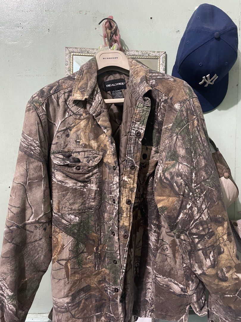 Real Tree Camo Button Up Jacket (Category: Coats, Jackets and Outerwear) located in Baguio. Submitted by claw_set (Listing ID 1462590578, Image 2). Description: - Classic Real Tree camouflage pattern - Button-up front closure - Two chest pockets for storage - Quilted lining for added warmth - Durable material, built to last - Perfect for outdoor adventures or everyday casual wear 22x28.