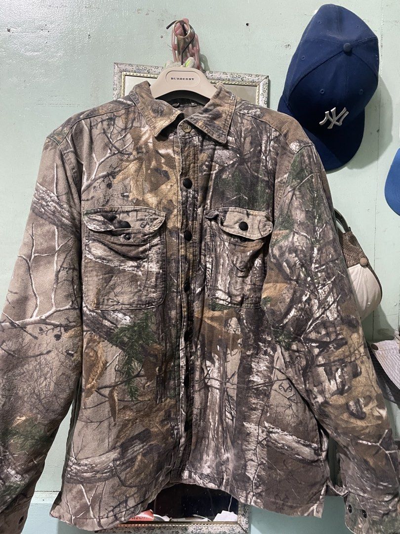 Real Tree Camo Button Up Jacket (Category: Coats, Jackets and Outerwear) located in Baguio. Submitted by claw_set (Listing ID 1462590578, Image 1). Description: - Classic Real Tree camouflage pattern - Button-up front closure - Two chest pockets for storage - Quilted lining for added warmth - Durable material, built to last - Perfect for outdoor adventures or everyday casual wear 22x28.