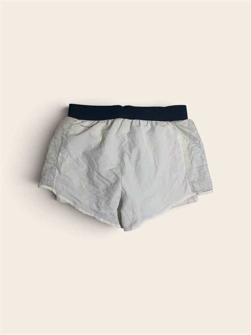 Reebok White Running Shorts with Mesh Panels (Category: Activewear) located in Davao. Submitted by youngboythrift25 (Listing ID 1462610107, Image 3). Description: - White Reebok running shorts - Dark blue waistband - Side mesh panels for enhanced breathability - Reebok logo and graphic print on the front - Lightweight material, ideal for workouts or casual wear - Elastic waistband for a comfortable and secure fit.