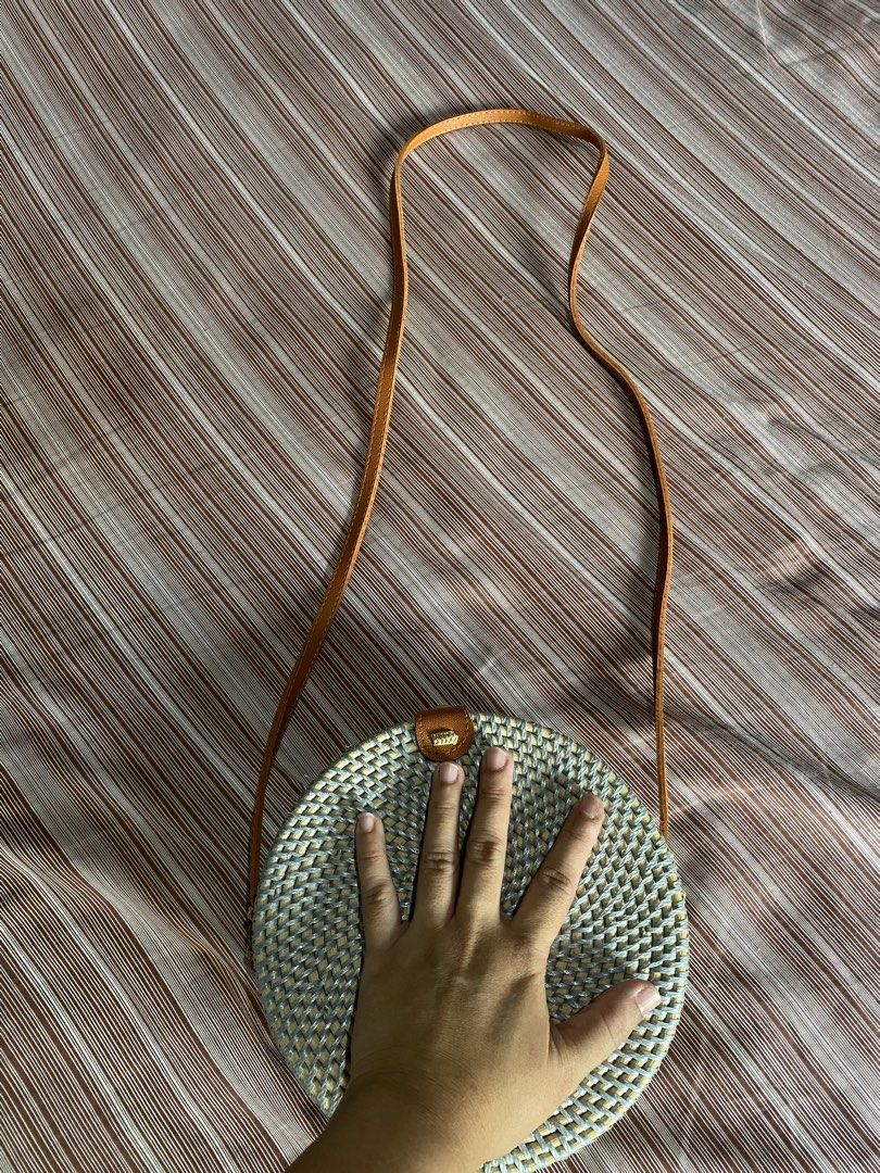 Round Rattan Sling Bag with Leather Strap (Category: Cross-body Bags) located in Silang. Submitted by iamjhestine (Listing ID 1462670556, Image 2). Description: - Cute round rattan bag - Natural woven material - Comes with a brown leather strap - Ideal for beach trips or casual outings - Small size, perfect for essentials - Unique texture and design.