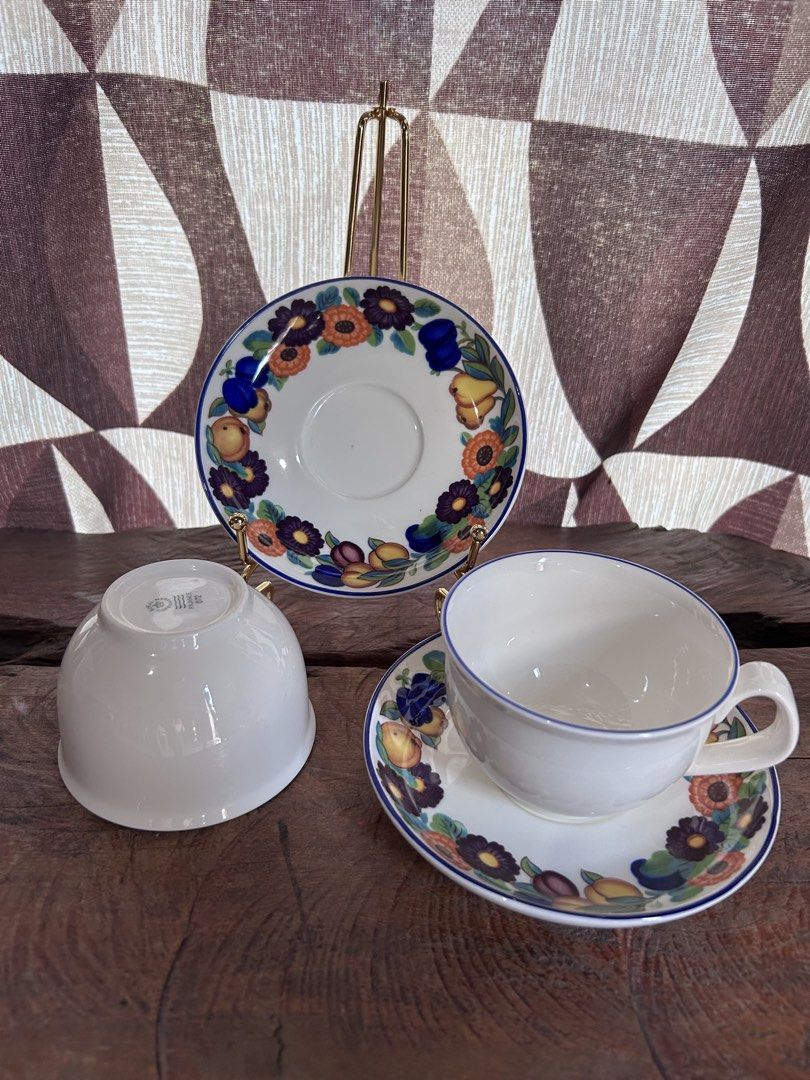 Royal Copenhagen Golden Summer (Category: Coffee & Tea Tableware) located in Bagabag. Submitted by estellasvintagefinds (Listing ID 1462456441, Image 1). Description: - Set of 2 vintage tea cups and saucers - Features a colorful floral and fruit pattern - Elegant blue rim detail - One cup shows maker's mark when upside down - Includes one cup on its saucer and a separate display saucer - Ideal addition to any tea time collection.