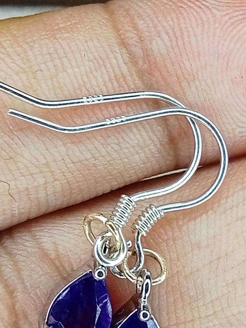 Ruby and silver 925 (hook)Amethyst Drop Earrings Set (Category: Earrings) located in Davao. Submitted by kimpoycaye62726 (Listing ID 1462648732, Image 3). Description: - Set of two pairs of earrings - Pair 1: Round red stones with small clear accent stones - Pair 2: Pear-shaped purple stones - Both feature S925 sterling silver hooks - Versatile for dressing up or everyday wear - Selling as a set.