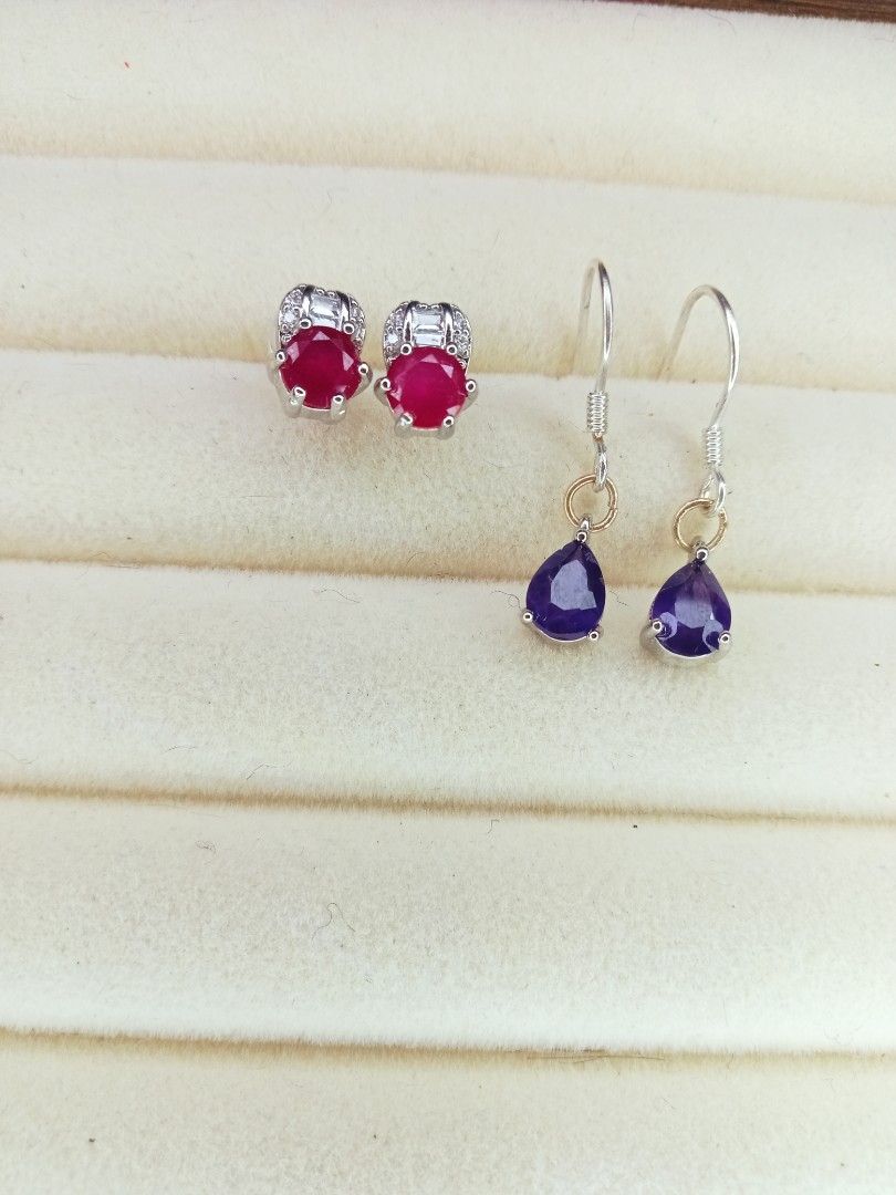Ruby and silver 925 (hook)Amethyst Drop Earrings Set (Category: Earrings) located in Davao. Submitted by kimpoycaye62726 (Listing ID 1462648732, Image 1). Description: - Set of two pairs of earrings - Pair 1: Round red stones with small clear accent stones - Pair 2: Pear-shaped purple stones - Both feature S925 sterling silver hooks - Versatile for dressing up or everyday wear - Selling as a set.