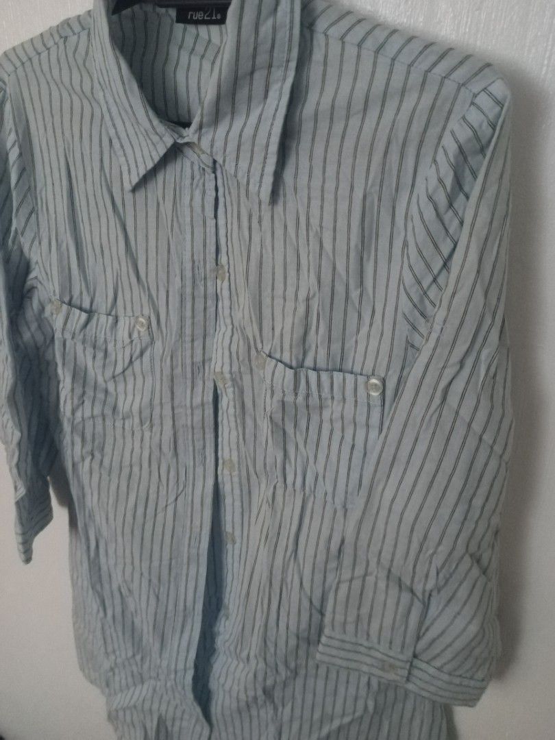 Rue21 Striped Button-Up Shirt (Category: Shirts) located in Marikina City. Submitted by airapreloved091826 (Listing ID 1462469588, Image 2). Description: - Light blue button-up shirt - Thin dark stripes - Two chest pockets with button closures - Three-quarter length sleeves - Relaxed fit - Ideal for casual wear.