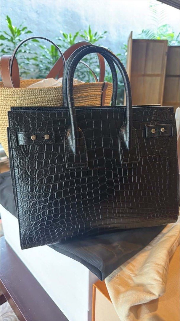 Saint Laurent Sac De Jour Bag (Category: Luxury Bags & Wallets) located in Manila. Submitted by kenmalabuyoc29 (Listing ID 1462442823, Image 2). Description: - Authentic Saint Laurent Sac De Jour bag - Color: Black - Material: Croc-embossed leather - Features: Top handles, detachable shoulder strap - Hardware: Silver - Interior: Clean - Versatile: Ideal for work or evening wear - Style: Classic piece.