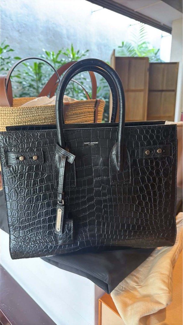 Saint Laurent Sac De Jour Bag (Category: Luxury Bags & Wallets) located in Manila. Submitted by kenmalabuyoc29 (Listing ID 1462442823, Image 1). Description: - Authentic Saint Laurent Sac De Jour bag - Color: Black - Material: Croc-embossed leather - Features: Top handles, detachable shoulder strap - Hardware: Silver - Interior: Clean - Versatile: Ideal for work or evening wear - Style: Classic piece.