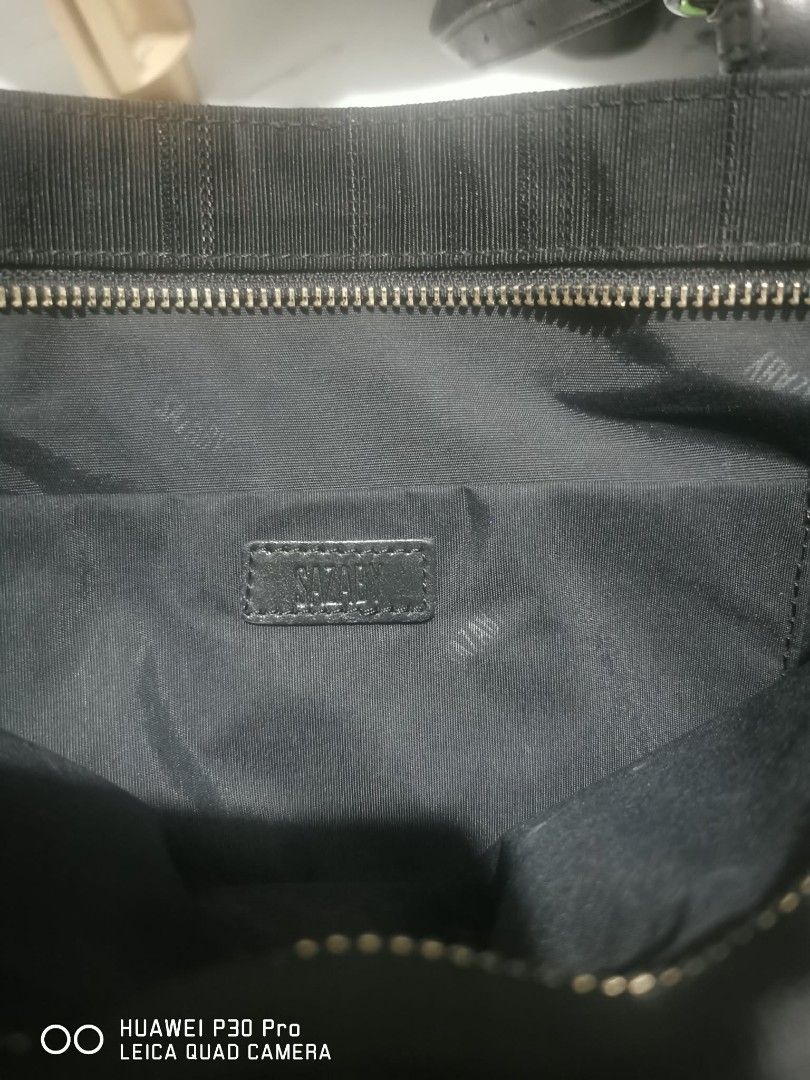 Sazaby Black Tote Bag (Category: Tote Bags) located in Makati City. Submitted by relianzmae57131 (Listing ID 1462471832, Image 1). Description: - Sazaby tote bag in classic black. - Crafted from textured fabric with elegant leather accents. - Secure zippered top closure. - Interior features a convenient zippered pocket. - Durable metal studs on the base for protection. - Comfortable shoulder straps for easy carrying..