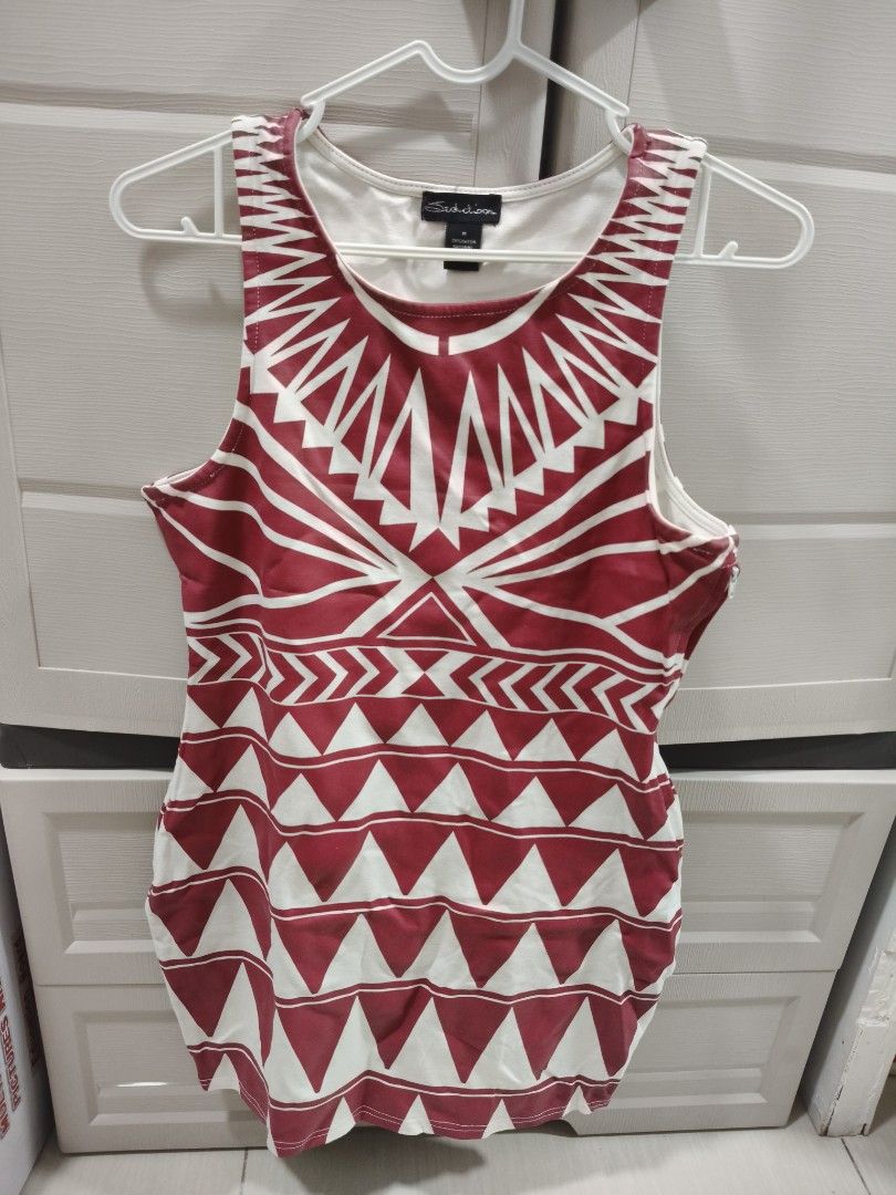 Seductions Red and White Geometric Print Tank Top Size M (Category: Sleeveless) located in Manila. Submitted by hellocaea010894 (Listing ID 1462601340, Image 1). Description: - Seductions Tank Top - Size: Medium (M) - Design: Red and white geometric print - Sleeveless - Material: 70% Rayon - Perfect for casual wear.