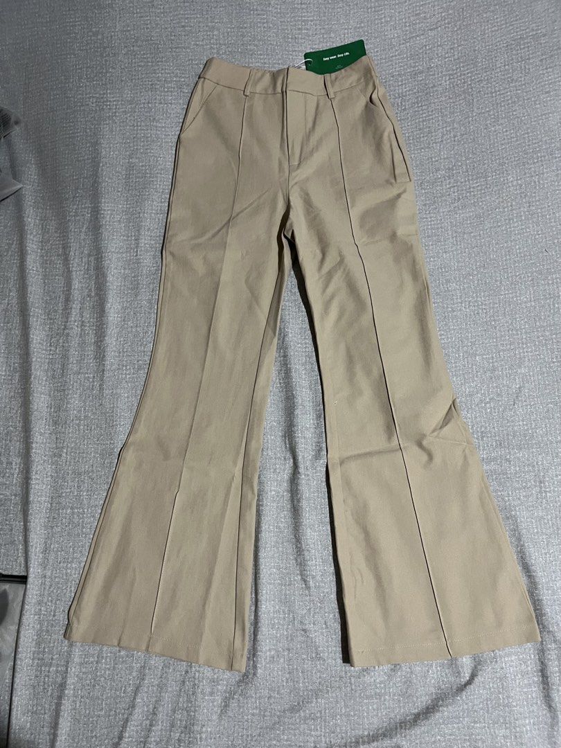 SHEIN Beige Flared Leg Pants (Category: Other Bottoms) located in Manila. Submitted by az0r_ (Listing ID 1462509470, Image 2). Description: - Beige flared leg pants from SHEIN - High-waisted with zipper and button closure - Features a seam down the front of each leg - Brand new with tags still attached - Versatile for dressing up or down.