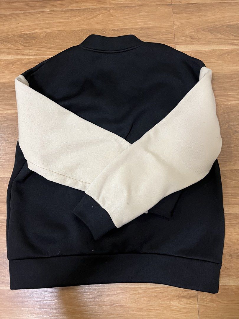 SHEIN Black & Beige Varsity Letterman Jacket (Category: Coats, Jackets and Outerwear) located in San Fernando. Submitted by nathan_pasahol (Listing ID 1462594559, Image 2). Description: - Black varsity jacket with beige sleeves - Features a large white 'B' patch on the chest - Button-up front closure - Ribbed collar, cuffs, and hem for a snug fit - Ideal for a casual, sporty aesthetic - Versatile: pairs well with jeans or leggings.