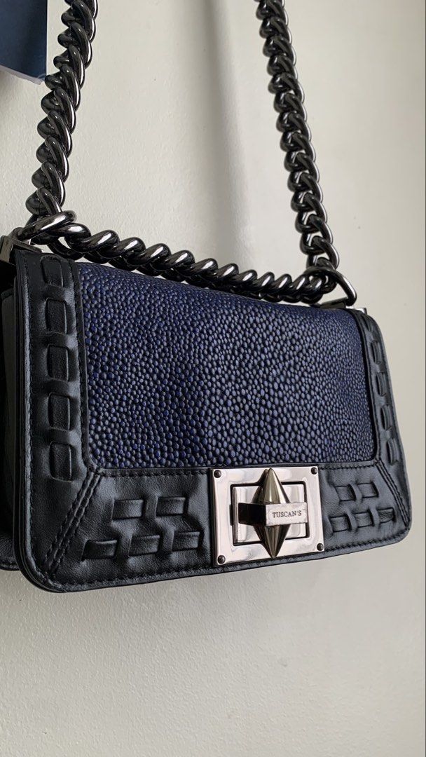 TUSCAN | shoulder/sling bag (Category: Shoulder Bags) located in Mandaluyong City. Submitted by fv_merch (Listing ID 1462628299, Image 3). Description: ₱ 850 TUSCAN | shoulder/sling bag (dark blue and black colorway); thick gunmetal chain-link strap Issues: Minor Sign of Usage; genuine leather More photos in comment section. ⚠ DISCLAIMER: All brand names, logos, and trademarks belong to their respective owners and are used for identification/auth