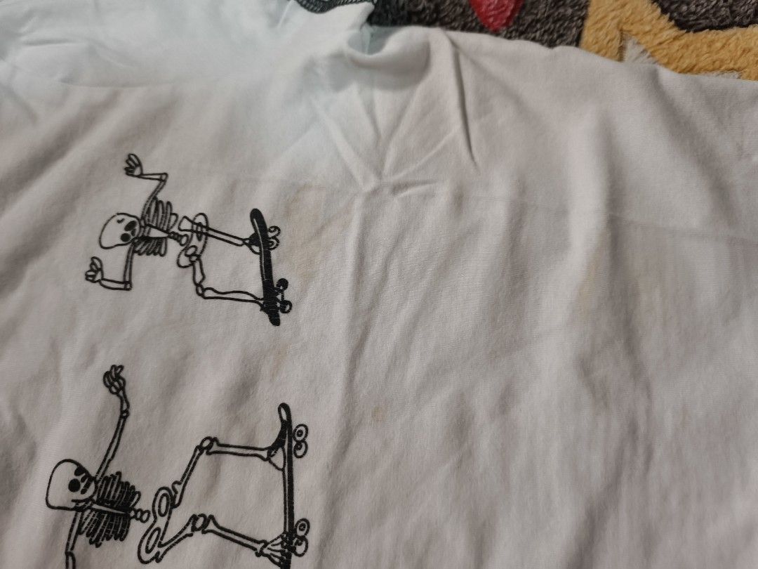 Skating Skeletons Graphic Crop Tee (Category: Shirts) located in Cebu City. Submitted by straw.berry.milk.24 (Listing ID 1462647744, Image 3). Description: - White crop top - Graphic print: Skeletons skateboarding - Short sleeves with contrast stitching - Size: Small - Condition: Some faint stains (please check photos for details).