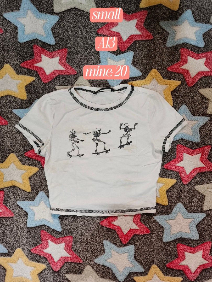 Skating Skeletons Graphic Crop Tee (Category: Shirts) located in Cebu City. Submitted by straw.berry.milk.24 (Listing ID 1462647744, Image 1). Description: - White crop top - Graphic print: Skeletons skateboarding - Short sleeves with contrast stitching - Size: Small - Condition: Some faint stains (please check photos for details).