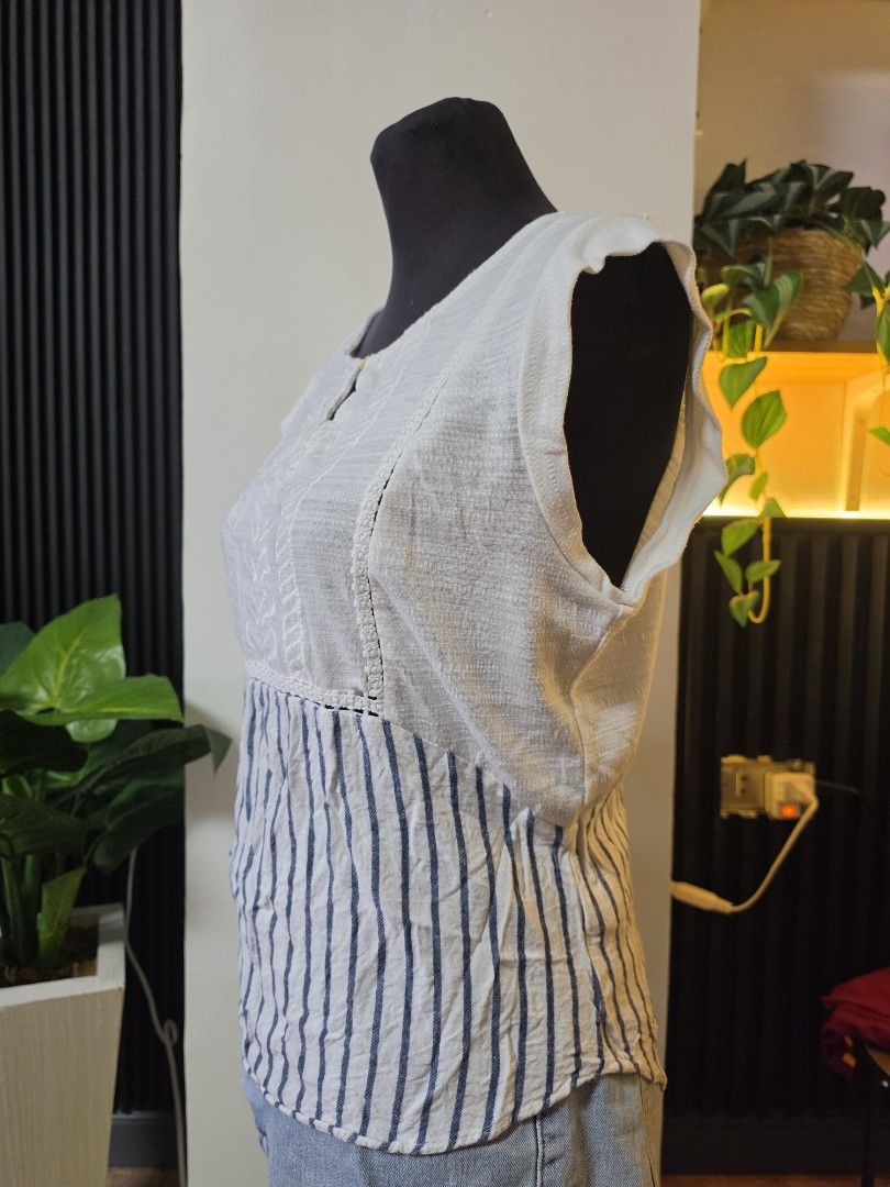 Skies Are Blue White Striped Patchwork Top Size S to medium (Category: Sleeveless) located in Paranaque City. Submitted by franinnashop (Listing ID 1462501850, Image 2). Description: - Unique white top with blue striped patchwork detail. - Features textured fabric on front and back. - Short sleeves and a stylish keyhole neckline with button closure. - Versatile design, pairs perfectly with jeans or shorts. - Comfortable and fashionable for everyd