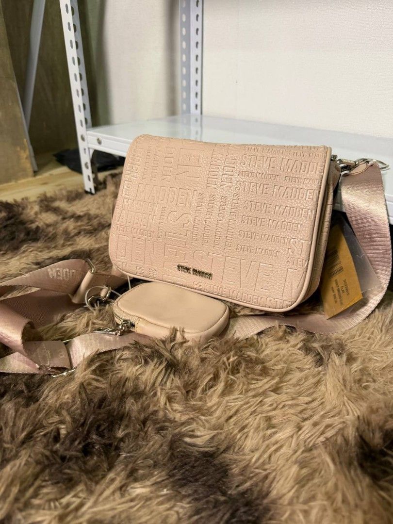 Steve Madden Pink Monogram Crossbody Bag with Pouch (Category: Cross-body Bags) located in Manila. Submitted by livegem.4c985e (Listing ID 1462603113, Image 1). Description: - Adorable pink Steve Madden crossbody bag - Features the brand's signature monogram print - Comes with a matching small pouch for cards or coins - Adjustable strap with Steve Madden branding - Ideal for everyday wear and errands.