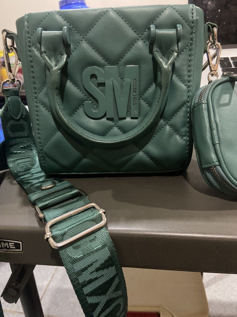 Steve Madden Quilted Green Handbag with Pouch (Category: Luxury Bags & Wallets) located in Manila. Submitted by gigstlauron (Listing ID 1462570007, Image 1). Description: - Stylish green quilted handbag from Steve Madden. - Comes with a matching small pouch. - Features a detachable crossbody strap with Steve Madden logo. - Interior lined with signature Steve Madden pattern. - Secure snap closure for the main compartment. - Ideal for everyday use.
