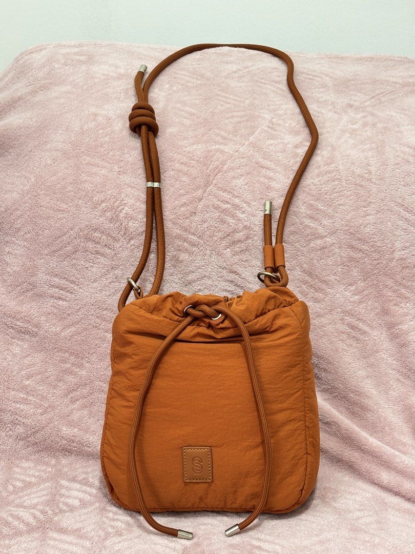 Straightforward- Willow slingbag (Category: Purses & Pouches) located in Quezon City. Submitted by nanas_closet756 (Listing ID 1462516155, Image 1). Description: Cute orange pouch bag. It has a drawstring closure and a long shoulder strap. The strap has a knot detail at the top. Small leather patch with an 'S' logo on the front. Great for carrying essentials..