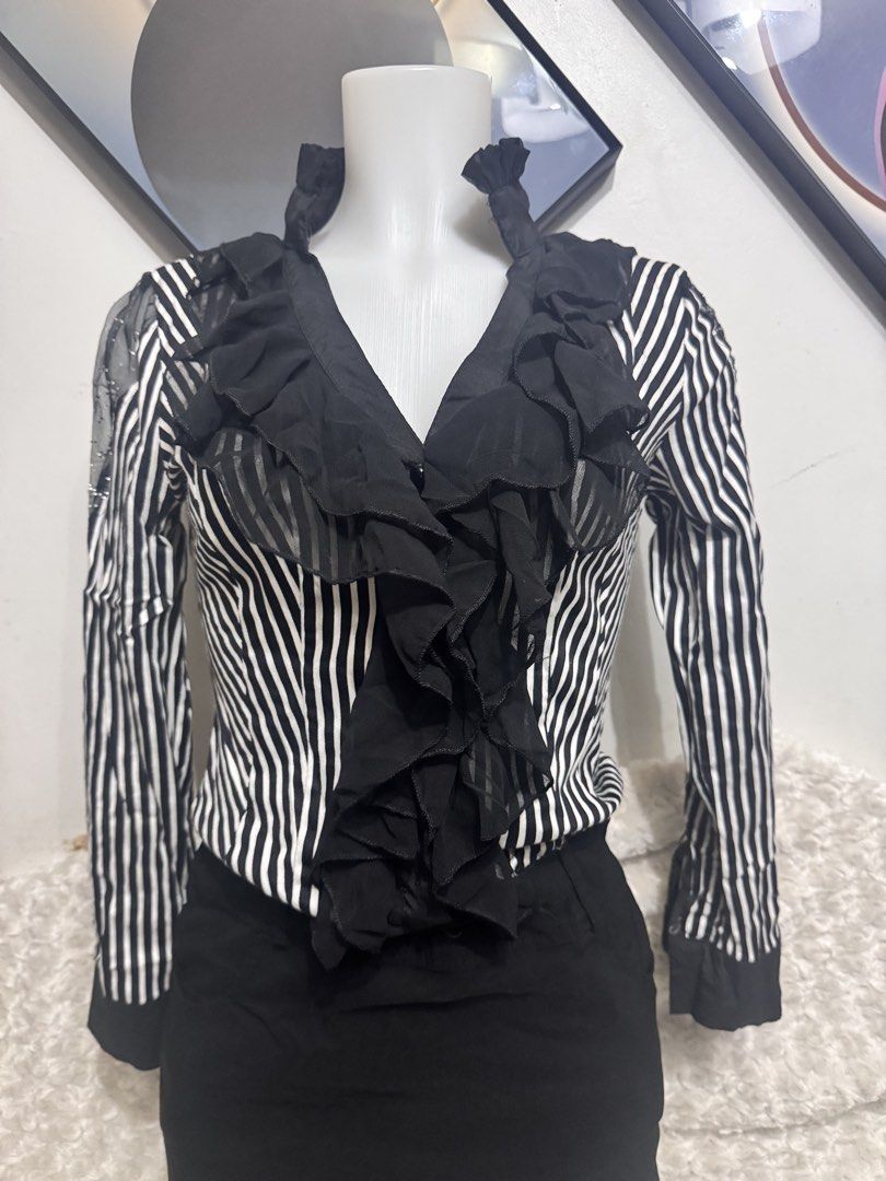 Striped Ruffle Blouse with Sheer Sleeves (Category: Longsleeves) located in Marikina City. Submitted by lorradel (Listing ID 1462461213, Image 2). Description: - fits M- L 34 bust - Classic black and white stripes - Ruffled front detail - Sheer sleeves with subtle embellishments - Button-up closure - Versatile for professional or chic outfits - Looks great tucked into skirts or trousers - MAY HAVE some washable stains (hindi maiiwasan) needs wash