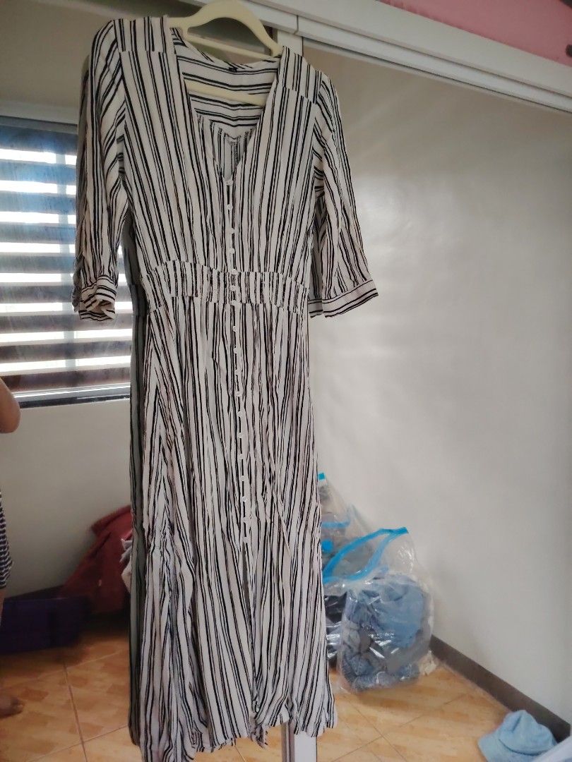 Striped V-Neck Button-Up Maxi Dress (Category: Dresses) located in Agdangan. Submitted by limeineghl (Listing ID 1462509118, Image 1). Description: - Elegant white and black striped maxi dress - Flattering V-neck with button-up front - Comfortable elasticated waist - Stylish three-quarter sleeves - Flowy skirt with a subtle slit - Versatile for casual or dressed-up looks.