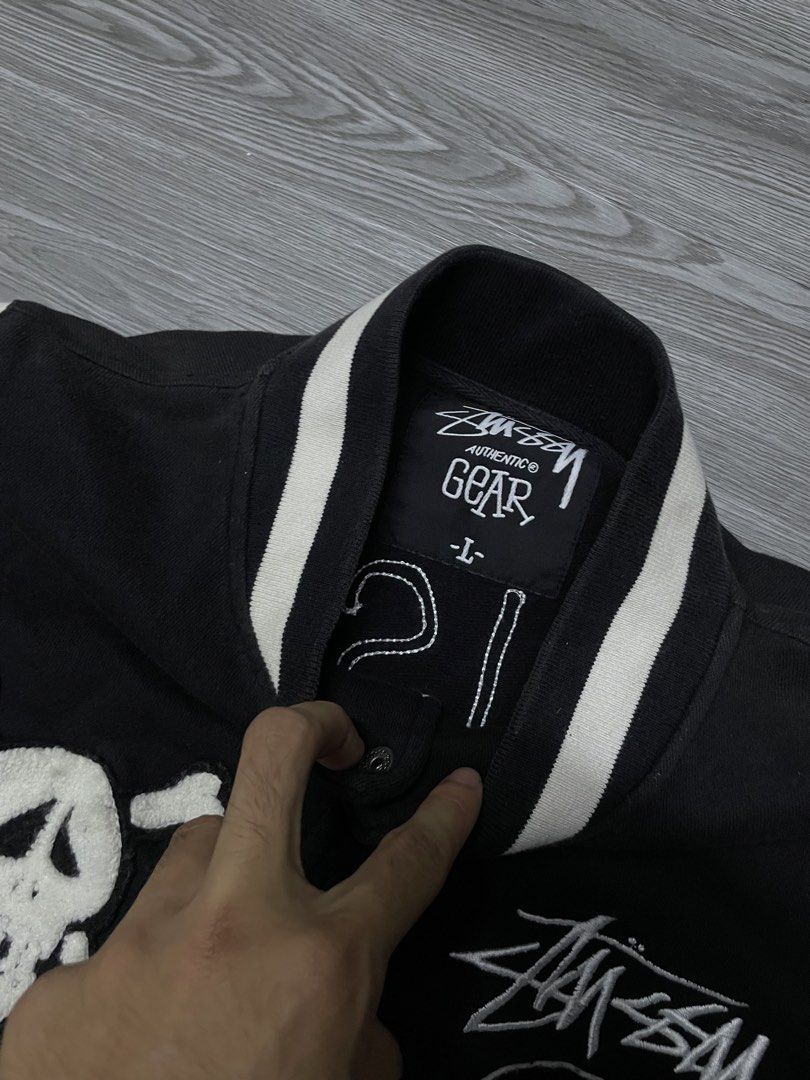 Stussy Skull & Crossbones Varsity Jacket (Category: Coats, Jackets and Outerwear) located in Manila. Submitted by yourfavoriteplug (Listing ID 1462507685, Image 3). Description: - Classic Black Stussy Varsity Jacket - White striped sleeves and collar for a retro look - Unique skull and crossbones patch on left chest - Prominent Stussy logos on right chest and back - Easy button-up closure - Size Large (L).
