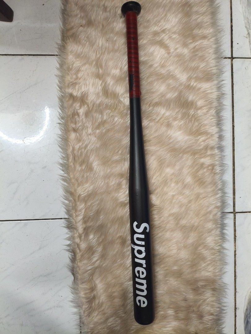 Supreme Baseball Bat (Category: Other Sports Equipment and Supplies) located in Manila. Submitted by tonio124 (Listing ID 1462562763, Image 1). Description: - Black baseball bat with iconic white Supreme logo. - Features a vibrant red grip on the handle. - Perfect for display or adding to your collection..