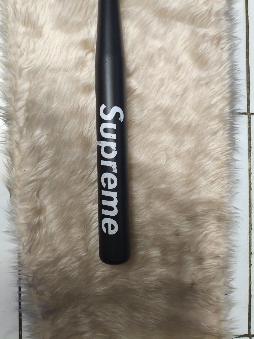 Supreme Baseball Bat (Category: Other Sports Equipment and Supplies) located in Manila. Submitted by tonio124 (Listing ID 1462562763, Image 2). Description: - Black baseball bat with iconic white Supreme logo. - Features a vibrant red grip on the handle. - Perfect for display or adding to your collection..