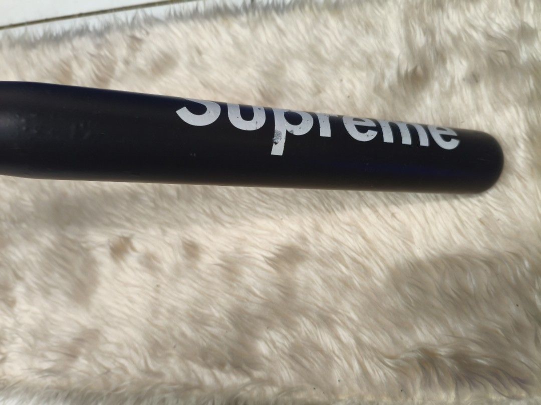 Supreme Baseball Bat (Category: Other Sports Equipment and Supplies) located in Manila. Submitted by tonio124 (Listing ID 1462562763, Image 3). Description: - Black baseball bat with iconic white Supreme logo. - Features a vibrant red grip on the handle. - Perfect for display or adding to your collection..
