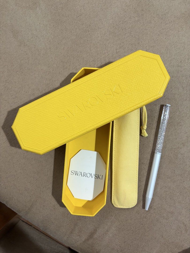 Swarovski Crystalline ballpoint pen (Category: Stationery & School Supplies) located in Manila. Submitted by yesapot (Listing ID 1462535724, Image 1). Description: - Authentic Swarovski pen - White barrel with sparkling crystal-filled top - Comes with original yellow case - Includes yellow pouch - Care instructions included - Features Swarovski logo on barrel - Ideal for gifting or personal use.