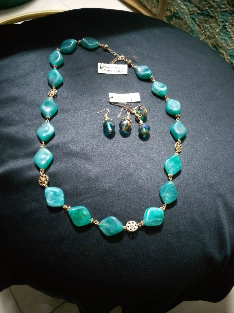 Teal Gemstone Necklace and Earrings Set (Category: Necklaces) located in Caloocan City. Submitted by maynaito (Listing ID 1462595092, Image 1). Description: - Beautiful teal gemstone necklace and matching earrings set. - Necklace features large, faceted teal stones with gold-tone metal accents. - Earrings have smaller teal beads and a sparkly accent. - Ideal for dressing up any outfit. - Brand new, with original price tag still attached..