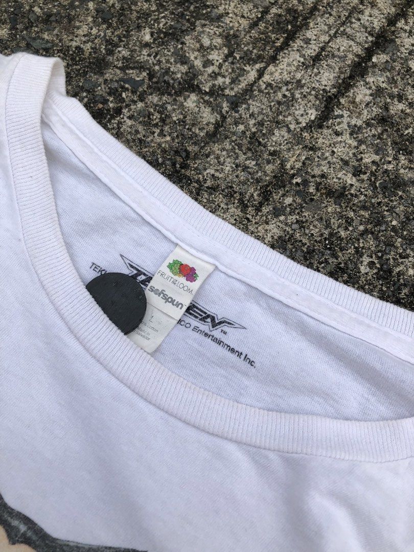 TEKKEN (Category: Formal Shirts) located in Manila. Submitted by thrift_neo (Listing ID 1462611750, Image 3). Description: Tekken Illustrated Character Group s19 Dual tag: Fotl hard tag, official printed tag size L on tag dimes 21x29 good condition issue:need wash, yellow stains.