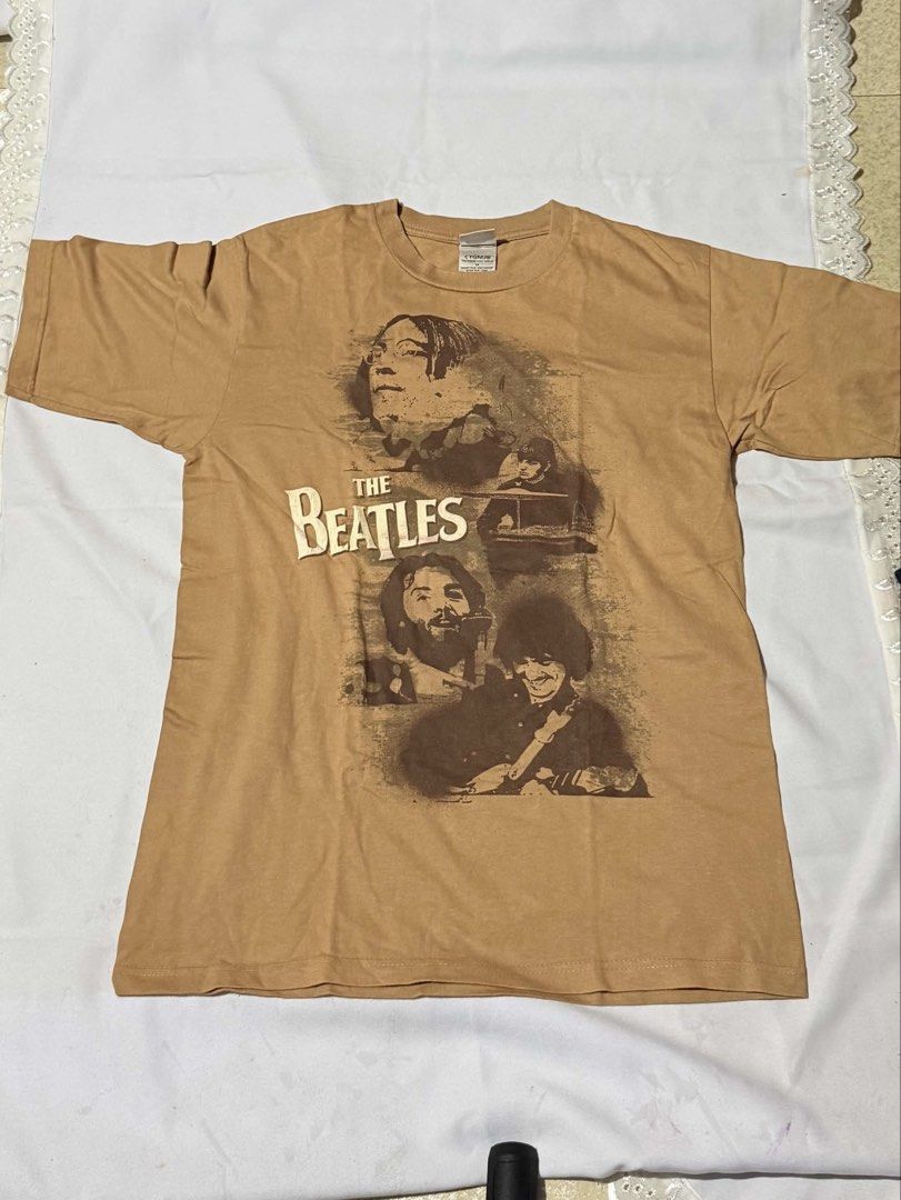 The Beatles Graphic T-Shirt (Category: Tshirts & Polo Shirts ) located in Manila. Submitted by simply.z.mnl (Listing ID 1462552424, Image 1). Description: - Brown t-shirt with a cool graphic print of The Beatles. - Made from 100% comfortable and breathable cotton. - Stylish and perfect for any Beatles fan..