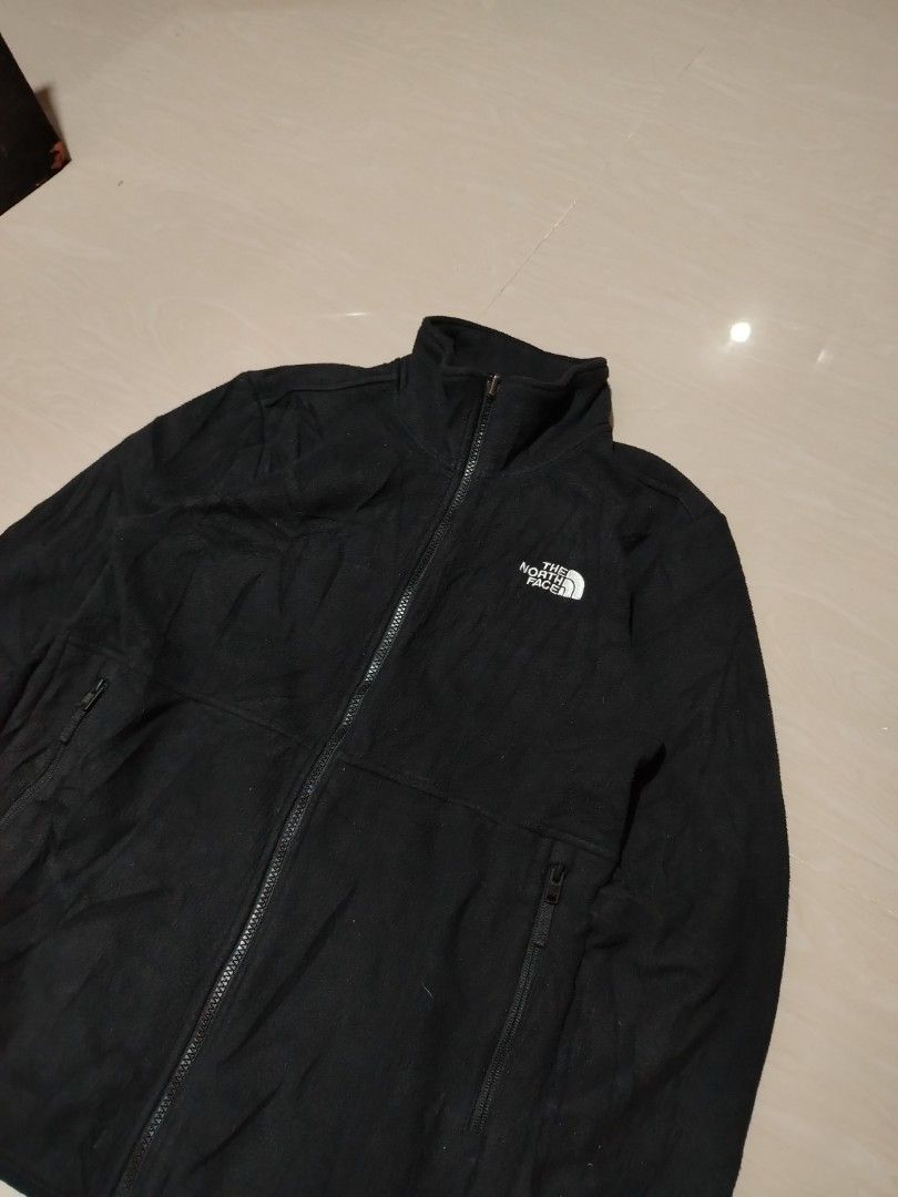 The North Face Black Fleece Jacket (Category: Coats, Jackets and Outerwear) located in Tagum. Submitted by kotasallys40096 (Listing ID 1462577768, Image 3). Description: - Brand: The North Face - Color: Black - Style: Fleece Jacket - Closure: Full zip - 20*26 - Pockets: Two zip pockets - Collar: Stand-up collar for extra warmth - Material: 100% Polyester - Care: Easy to care for - Versatile: Great for layering or wearing on its own.