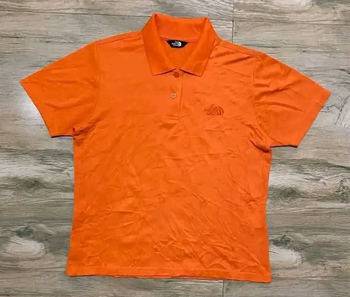 The North Face Orange Polo Shirt (Category: Shirts) located in San Carlos City. Submitted by roseee_012 (Listing ID 1462673009, Image 1). Description: - The North Face Orange Polo Shirt - Size 90 - Made in Korea - Features Coolmax technology for enhanced breathability - Embroidered logo on the chest - Small button closure at the neck - Ideal for sports or casual wear.