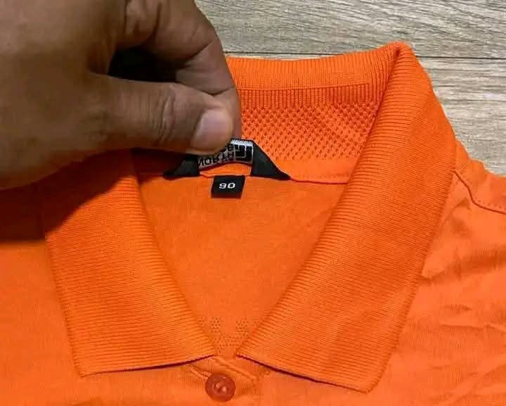 The North Face Orange Polo Shirt (Category: Shirts) located in San Carlos City. Submitted by roseee_012 (Listing ID 1462673009, Image 3). Description: - The North Face Orange Polo Shirt - Size 90 - Made in Korea - Features Coolmax technology for enhanced breathability - Embroidered logo on the chest - Small button closure at the neck - Ideal for sports or casual wear.
