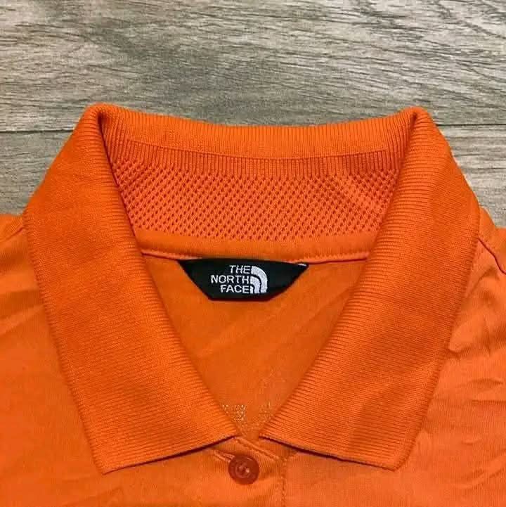 The North Face Orange Polo Shirt (Category: Shirts) located in San Carlos City. Submitted by roseee_012 (Listing ID 1462673009, Image 2). Description: - The North Face Orange Polo Shirt - Size 90 - Made in Korea - Features Coolmax technology for enhanced breathability - Embroidered logo on the chest - Small button closure at the neck - Ideal for sports or casual wear.