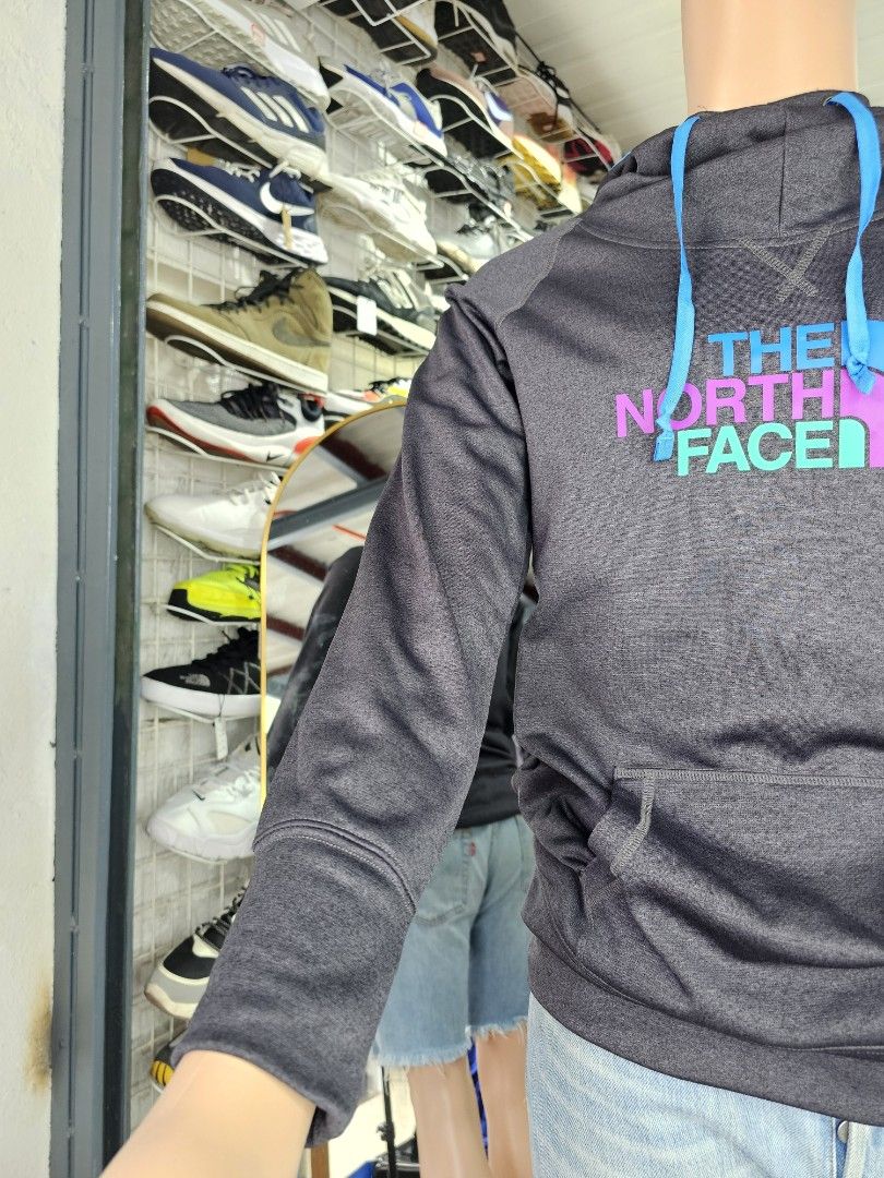 The North Face pullover hoodie (Category: Coats, Jackets and Outerwear) located in Baguio. Submitted by kayeonlineshop (Listing ID 1462560048, Image 3). Description: -charcoal grey The North Face pullover hoodie featuring a vibrant pink and turquoise logo on the chest. -Measurements included in the photos.