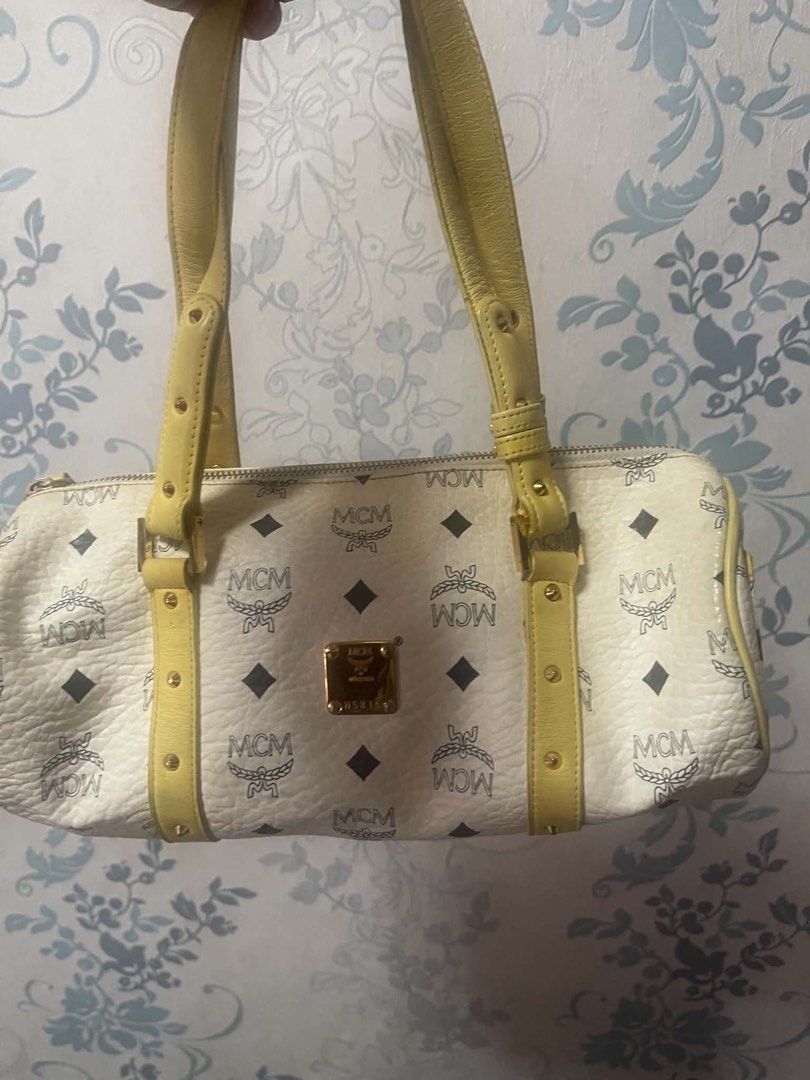 [THRIFTED] MCM Monogram Boston Bag White Yellow Leather (Category: Luxury Bags & Wallets) located in Cainta. Submitted by gamityen (Listing ID 1462492810, Image 1). Description: ‼️ PLEASE READ BEFORE PROCEEDING ‼️ Thrifted authentic MCM Monogram Boston Bag. White with yellow leather trim. All-over MCM logo print. Gold hardware. Zipper closure. Top handles. Shoulder bag. RF: need funds IMPORTANT NOTES: - FREE SHIPPING thru J&T - Does NOT come with