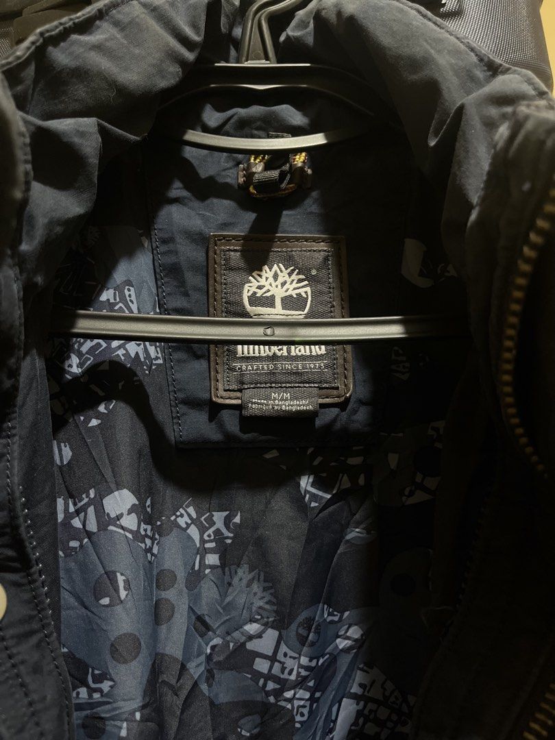 Timberland Navy Blue Field Jacket M/M (Category: Coats, Jackets and Outerwear) located in Manila. Submitted by jezrathrift (Listing ID 1462673355, Image 3). Description: - Navy blue Timberland field jacket - Size: Medium (M) - Unique patterned lining inside - Multiple functional pockets on the front - Secure zipper and button closure - Perfect for layering in cooler weather - Great for outdoor activities and everyday casual wear.