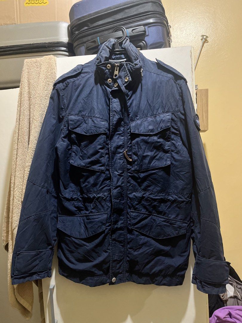 Timberland Navy Blue Field Jacket M/M (Category: Coats, Jackets and Outerwear) located in Manila. Submitted by jezrathrift (Listing ID 1462673355, Image 1). Description: - Navy blue Timberland field jacket - Size: Medium (M) - Unique patterned lining inside - Multiple functional pockets on the front - Secure zipper and button closure - Perfect for layering in cooler weather - Great for outdoor activities and everyday casual wear.