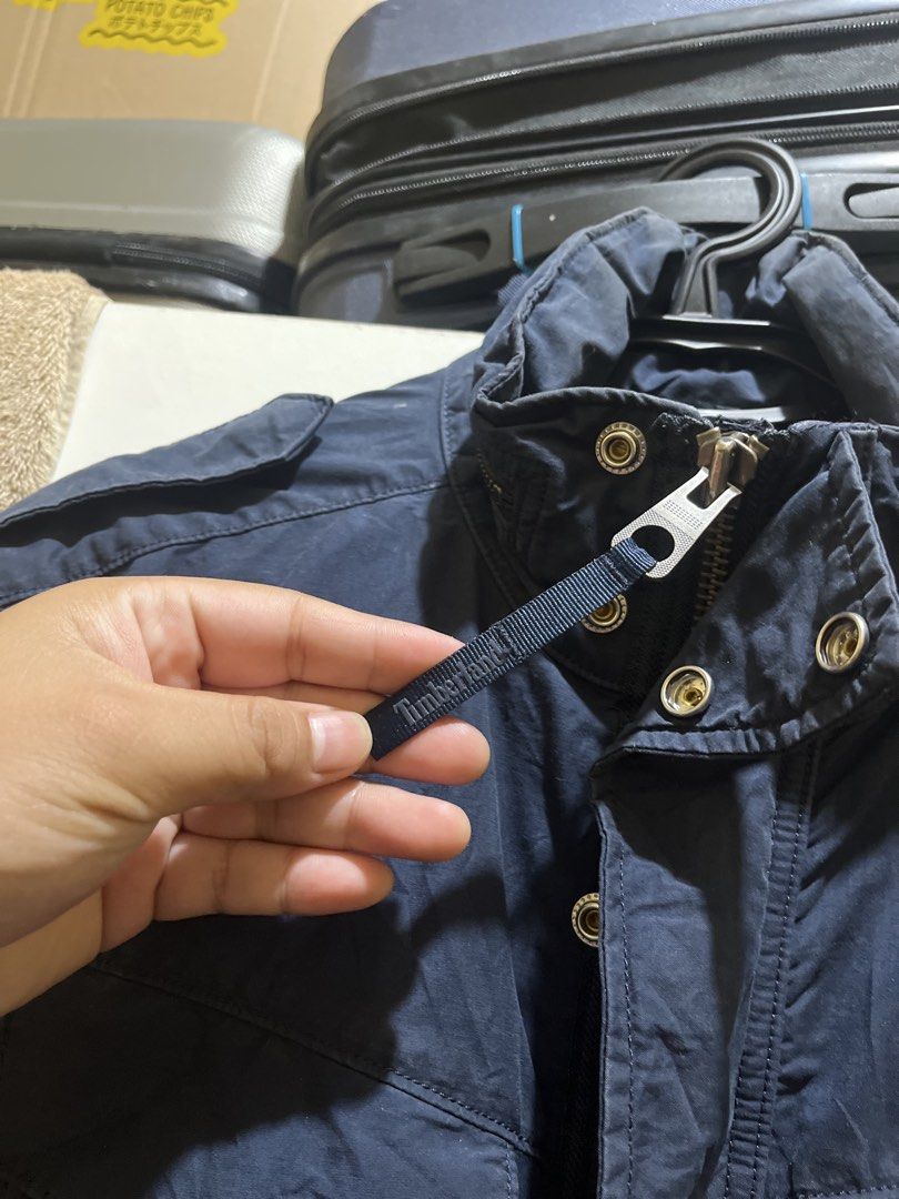 Timberland Navy Blue Field Jacket M/M (Category: Coats, Jackets and Outerwear) located in Manila. Submitted by jezrathrift (Listing ID 1462673355, Image 2). Description: - Navy blue Timberland field jacket - Size: Medium (M) - Unique patterned lining inside - Multiple functional pockets on the front - Secure zipper and button closure - Perfect for layering in cooler weather - Great for outdoor activities and everyday casual wear.