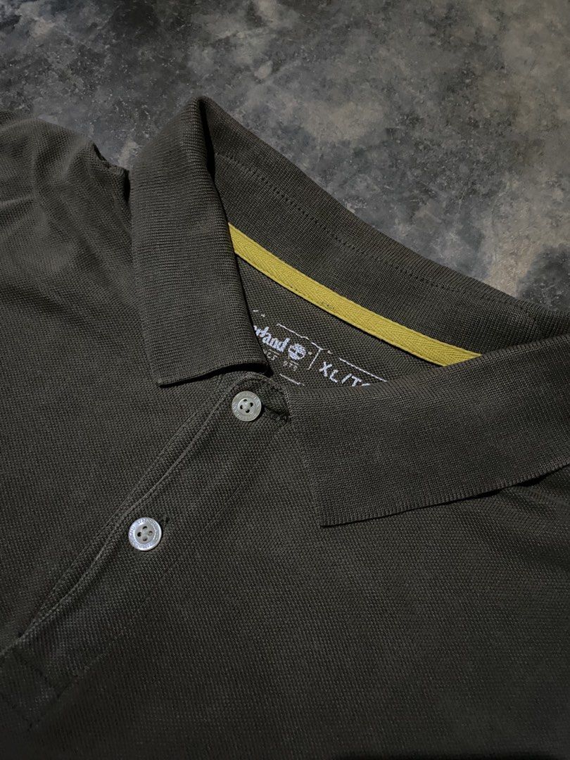 Timberland Polo Shirt XL (Category: Tshirts & Polo Shirts ) located in Caloocan City. Submitted by remythrift (Listing ID 1462609132, Image 3). Description: - Olive green Timberland polo shirt - Size XL - White and yellow stripe across the chest - Embossed Timberland logo detail - Perfect for casual wear - Please check photos for detailed condition.