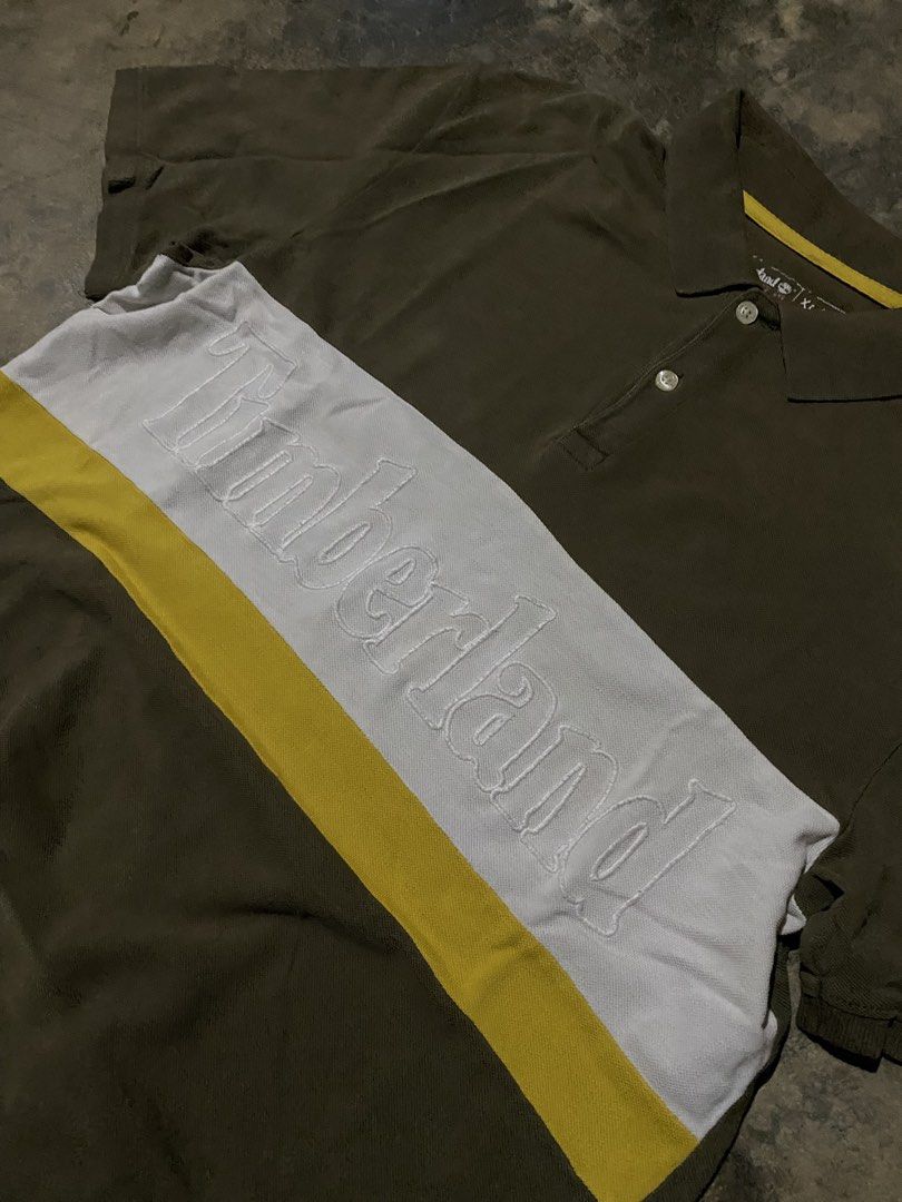 Timberland Polo Shirt XL (Category: Tshirts & Polo Shirts ) located in Caloocan City. Submitted by remythrift (Listing ID 1462609132, Image 2). Description: - Olive green Timberland polo shirt - Size XL - White and yellow stripe across the chest - Embossed Timberland logo detail - Perfect for casual wear - Please check photos for detailed condition.
