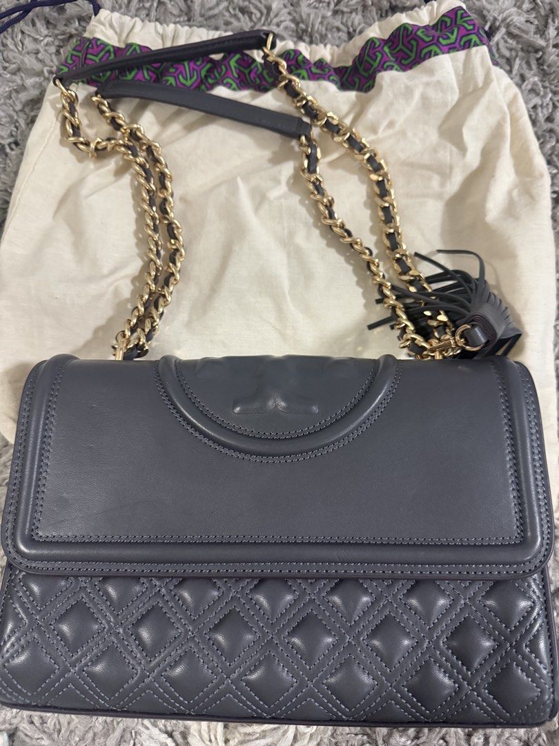 tory burch (Category: Luxury Bags & Wallets) located in Pasig City. Submitted by janiecruzaban (Listing ID 1462474750, Image 1). Description: - Authentic Tory Burch fleming chain wallet - Color: Grey leather - Hardware: Gold chain strap with leather detail - Accent: Side tassel - Interior: Multiple card slots and a zip pocket - Includes: Original dust bag - Versatile: Ideal for both day and evening use.