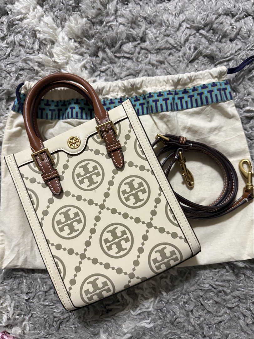 Tory burch (Category: Luxury Bags & Wallets) located in Pasig City. Submitted by janiecruzaban (Listing ID 1462477095, Image 1). Description: - 100% authentic - Tory Burch mini tote - Color: Cream with grey Tory Burch logo print - Material: Leather handles and trim - Includes original dust bag - Ideal for carrying everyday essentials.