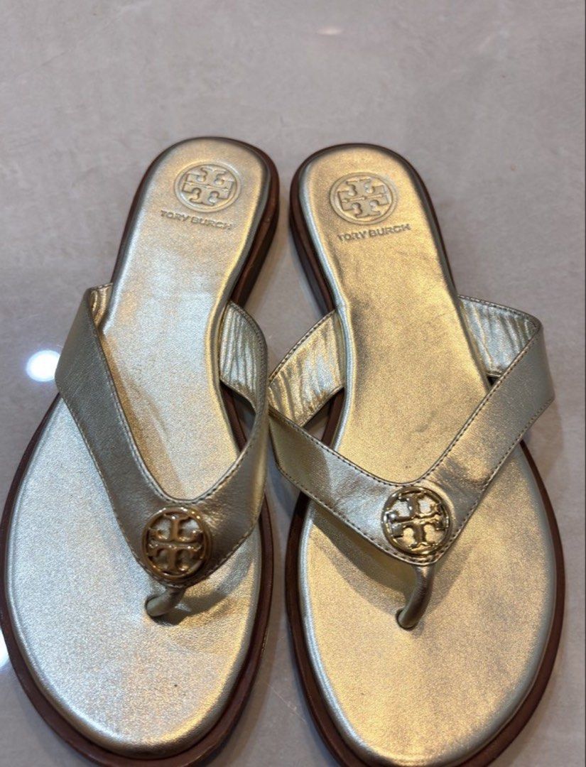 Tory Burch Gold Thong Flats Sandals (Category: Flats & Sandals) located in Pasig City. Submitted by allureapparel.mnl (Listing ID 1462628795, Image 1). Description: Last price already posted Non-nego unless getting multiple items Reposting - accidentally deleted original listing Size 6 - 23 cm.