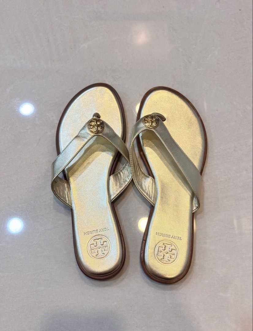Tory Burch Gold Thong Flats Sandals (Category: Flats & Sandals) located in Pasig City. Submitted by allureapparel.mnl (Listing ID 1462628795, Image 2). Description: Last price already posted Non-nego unless getting multiple items Reposting - accidentally deleted original listing Size 6 - 23 cm.